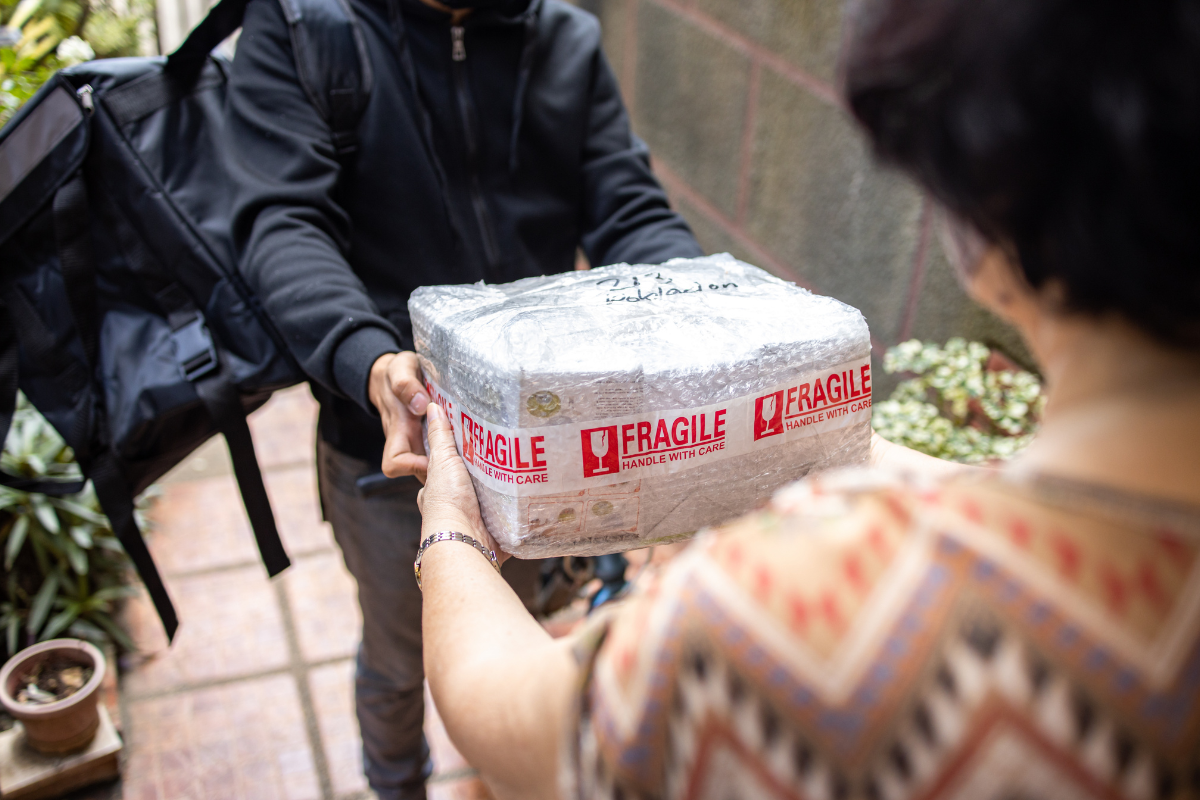 Courier handing off a package for same day delivery